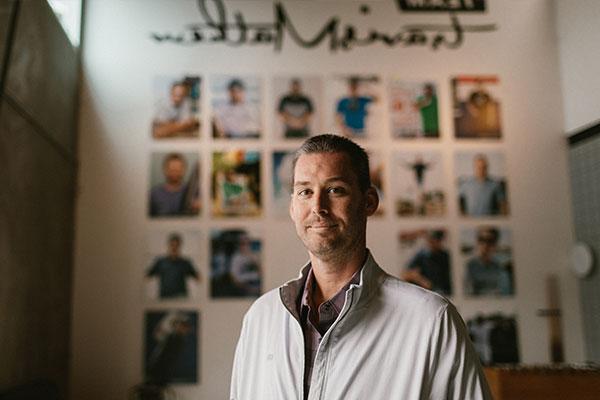 Ryan standing in front of 特拉维斯马修 Team wall